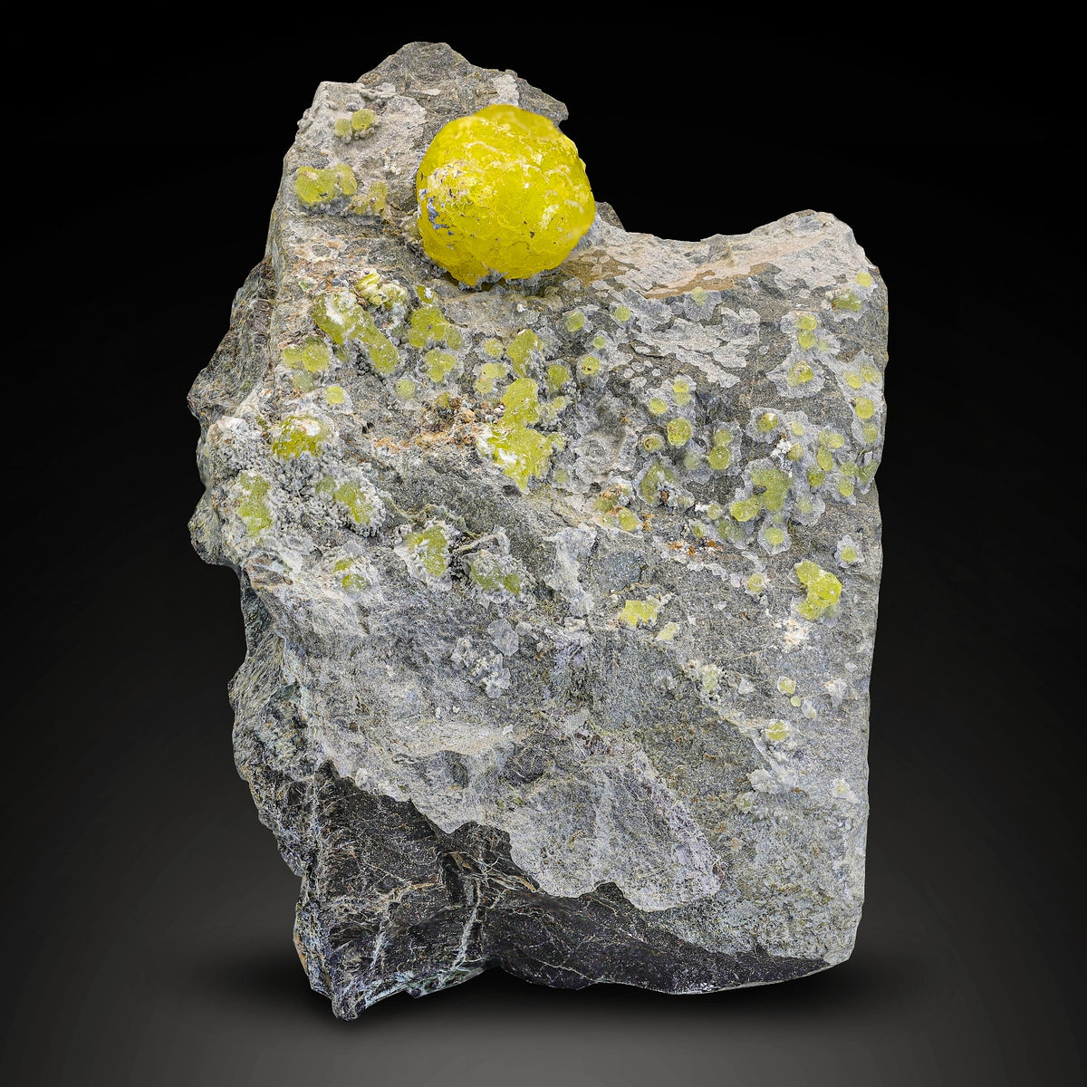 Lemon-yellow Brucite crystal perched on Chromite matrix