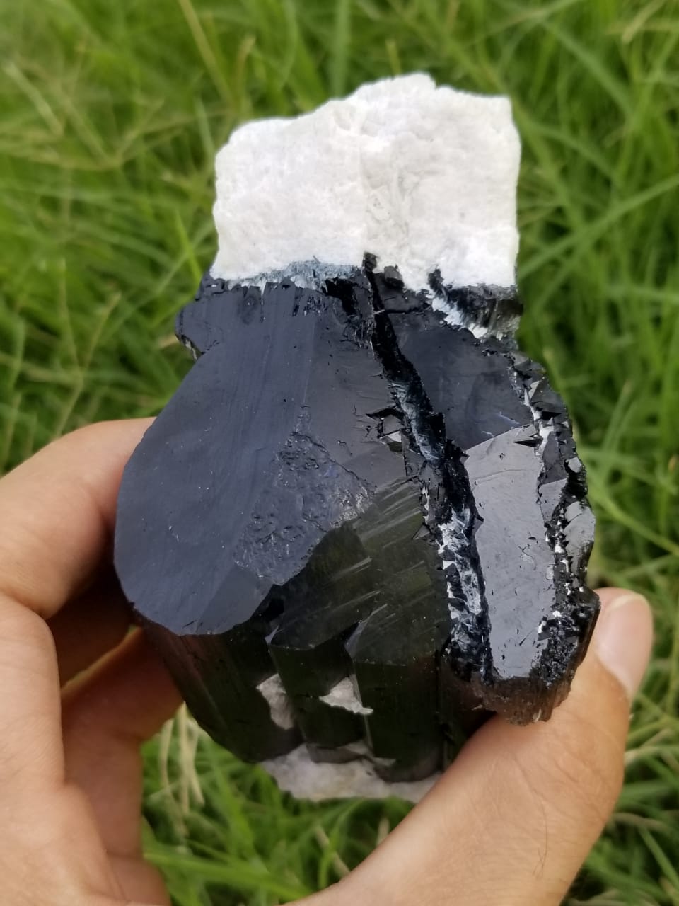 Metalic luster black tourmaline crystals with feldspar