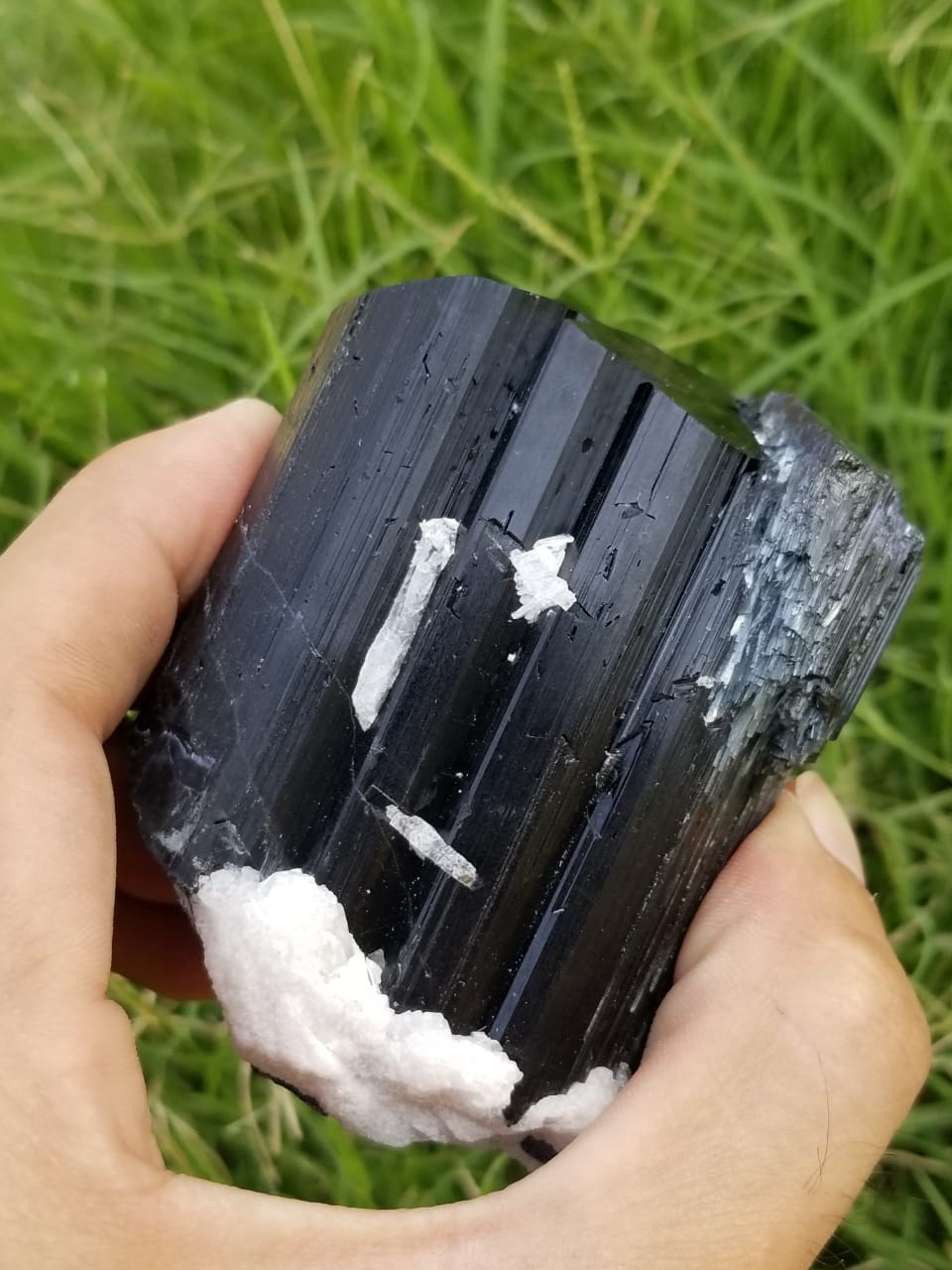 Metalic luster black tourmaline crystals with feldspar