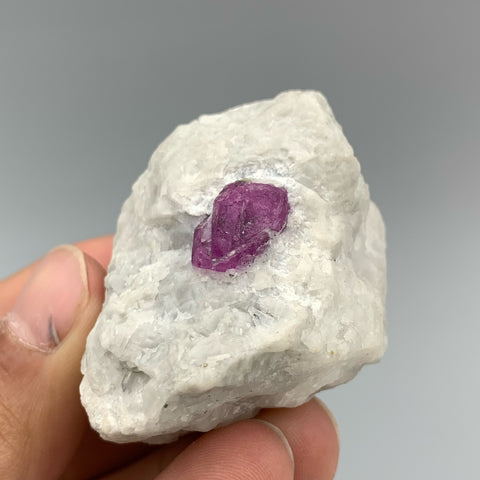 Vibrant Purple Ruby Crystal Nicely Positioned On White Marble Matrix